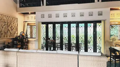 a living room with a large window with a view at Cempaka Villa in Pesanggaran