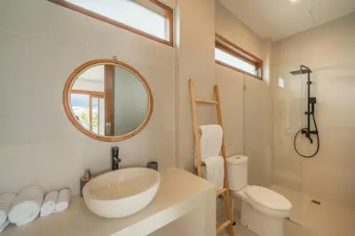 a bathroom with a sink and a toilet and a mirror at Cute 2 Bedrooms Villa in Canggu in Canggu