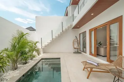 an indoor swimming pool in a villa with a patio at Cute 2 Bedrooms Villa in Canggu in Canggu