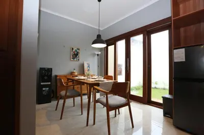 a kitchen with a dining room table and chairs at Rivera Seminyak 1 in Seminyak