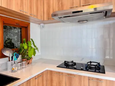 a kitchen with a stove top oven in a kitchen at Budayana Villa in Jimbaran