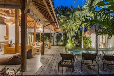 an outdoor patio with a pool and chairs at Central Oberoi Seminyak Newly Renovated Villa Riva in Seminyak