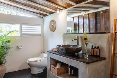 a bathroom with a sink and a toilet at Central Oberoi Seminyak Newly Renovated Villa Riva in Seminyak