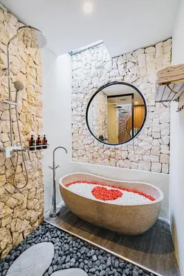 a bathroom with a large tub and a mirror at iRini Villas in Nusa Dua
