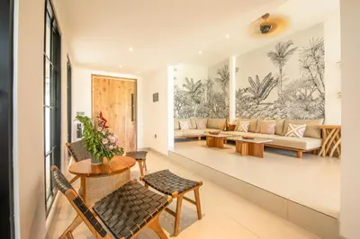 a living room with a couch and tables at 4 Bd Seminyak Scenic Rice Views 4 mins to Beach in Seminyak