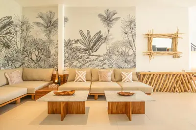 a living room with couches and a mural of palm trees at 4 Bd Seminyak Scenic Rice Views 4 mins to Beach in Seminyak