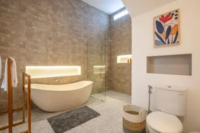 a bathroom with a tub and a toilet at 4 Bd Seminyak Scenic Rice Views 4 mins to Beach in Seminyak
