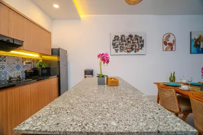 a kitchen with a granite counter top in a room at Villa Radha Seminyak in Seminyak