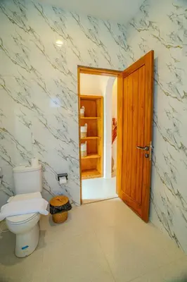 a bathroom with a toilet and a open door at Villa Radha Seminyak in Seminyak