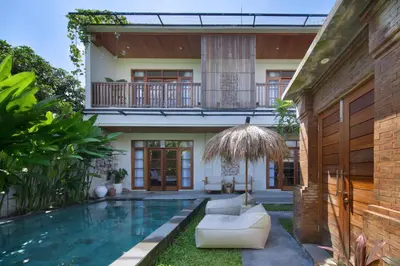 a villa with a swimming pool and a house at Villa Reviva - 3BR Seminyak in Seminyak