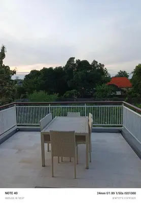 a table and chairs on a balcony with a table and chairs at Lucky Villa Jimbaran Penta in Jimbaran