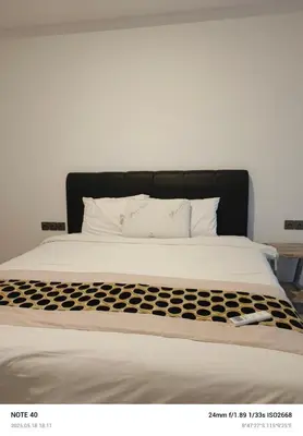 a large bed with a black and white comforter at Lucky Villa Jimbaran Penta in Jimbaran