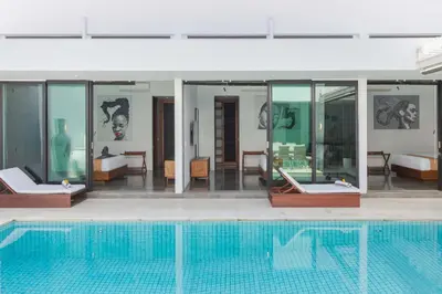 a house with a swimming pool in front of it at Stylish 3BR Villa with Swim-Up Bar in Seminyak in Seminyak