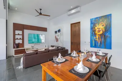 a living room with a table and a couch at Stylish 3BR Villa with Swim-Up Bar in Seminyak in Seminyak
