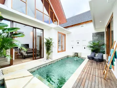 an indoor swimming pool in a home with a house at Villa De Tutti - 2BR Pool Villa Near Seminyak in Seminyak