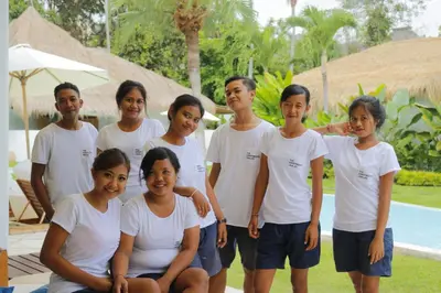 a group of people posing for a picture by a pool at The Apartments Umalas in Canggu