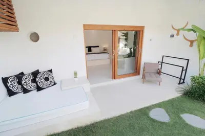 a living room with a couch and a chair at The Apartments Umalas in Canggu