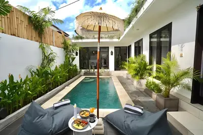 a pool in a house with a table with food on it at Villa Mimoza Umalas Bali in Kerobokan