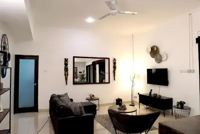 a living room with a couch and a mirror at Villa Mimoza Umalas Bali in Kerobokan