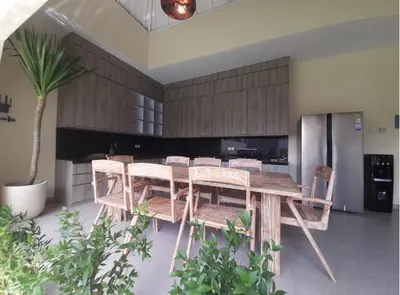 a dining room with a wooden table and chairs at Villa Rova in Kerobokan