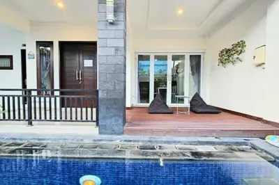 a house with a swimming pool in front of a house at 4 Bedroom Home with Pool near Canggu and Seminyak in Kerobokan