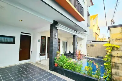 an external view of a house with a fish tank at 4 Bedroom Home with Pool near Canggu and Seminyak in Kerobokan