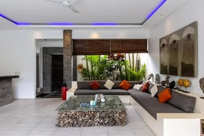 a living room with a couch and a table at Villa Naema by Pertama Management in Seminyak
