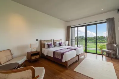 a bedroom with a bed and a large window at Villa Merengue by BaliSuperHost in Seminyak
