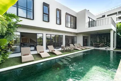 an exterior view of a house with a swimming pool at Villa Merengue by BaliSuperHost in Seminyak