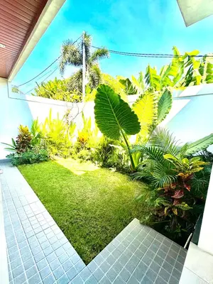 a garden with green grass and plants in a house at Mahayasa Villa with garden in Canggu
