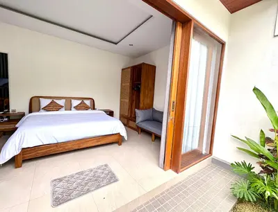 a bedroom with a bed and a window at Mahayasa Villa with garden in Canggu