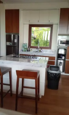 a kitchen with a counter and a window in it at Avela bali villa in Kerobokan