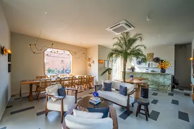 a living room filled with furniture and a table at Anam Tang New Rooms & Cafe near Seminyak in Seminyak