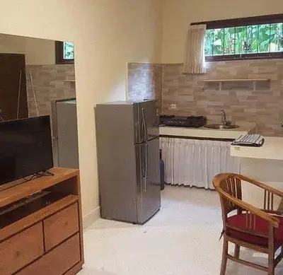 a kitchen with a stainless steel refrigerator and a sink at Rach APT in Kerobokan