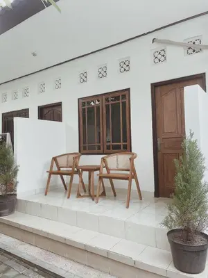 a patio with a table and chairs on a house at Sukanadi's Homestay in Legian