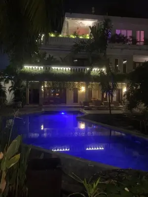 a swimming pool at night with blue lights at Heart of Seminyak 2bed 2bath 2 pools super quiet in Seminyak