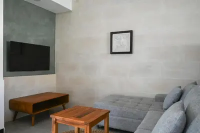 a living room with a couch and a tv at Villa Taman Sari in Nusa Dua