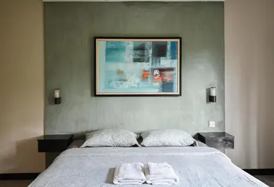 a bedroom with a bed with two towels on it at Villa Taman Sari in Nusa Dua