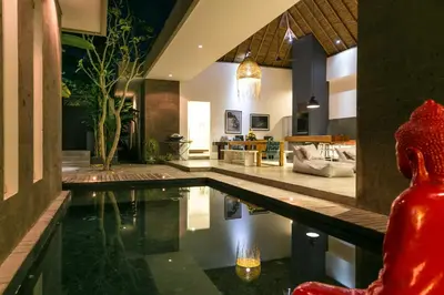 a house with a pool in the middle of a living room at Villa Turtle in Seminyak
