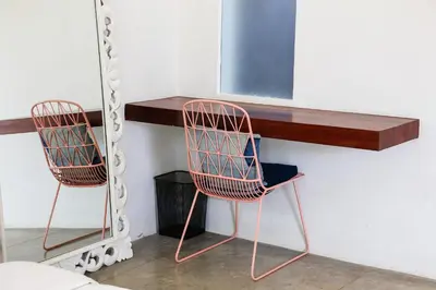 two chairs sitting under a desk with a shelf at Villa Turtle in Seminyak