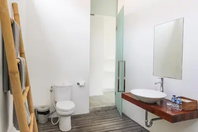 a bathroom with a toilet and a sink at Villa Turtle in Seminyak