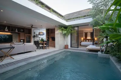 a swimming pool in a house with a living room at Deo Villa Seminyak in Seminyak