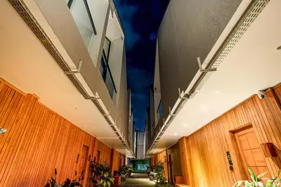 a long hallway with wooden walls and a blue ceiling at Premier Umalas Villa by Betterplace in Canggu