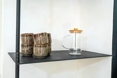 a shelf with three bowls and a glass jar on it at 2 bedroom villa with large garden and near Canggu in Kerobokan