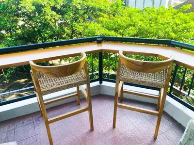 two chairs sitting on top of a balcony at Bali Bliss Jayakarta Apartments in Seminyak