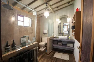 a bathroom with a sink and a toilet and a mirror at Villa Olita in Canggu