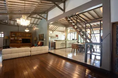 a living room with a white couch and a dining room at Villa Olita in Canggu