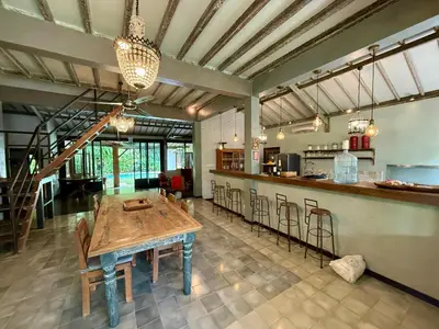 a large kitchen with a wooden table and chairs at Villa Olita in Canggu