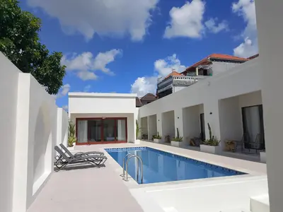 a swimming pool in the backyard of a house at Apartemen JIRO BALI in Ngurah Rai International Airport