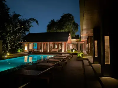 a house with a swimming pool at night at Jeeva Tirta Seminyak in Canggu